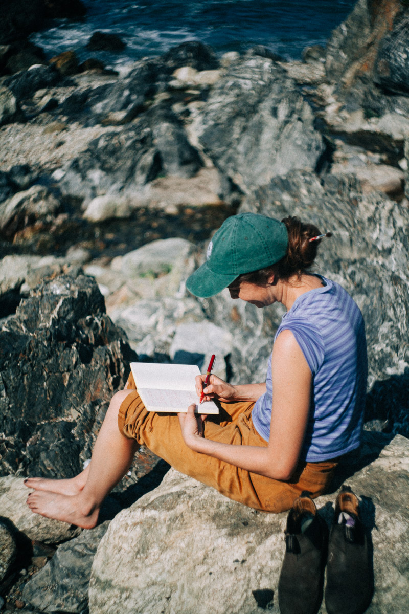 a person journaling on the rocks