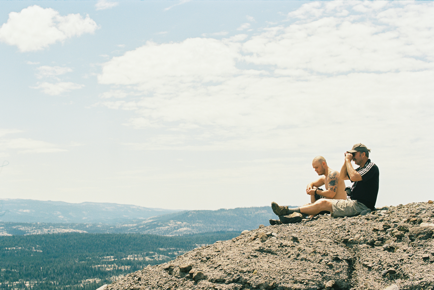 two people sit at an overlook