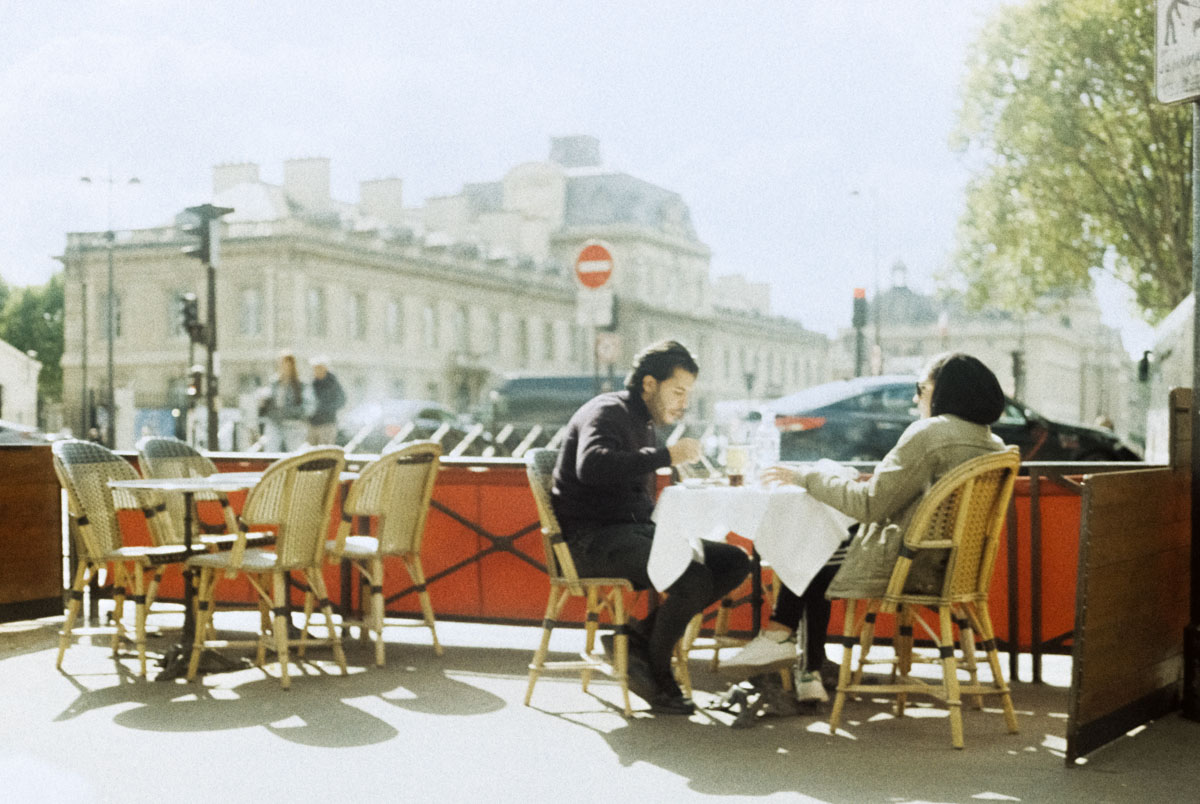a couple eating at a bistro in Paris