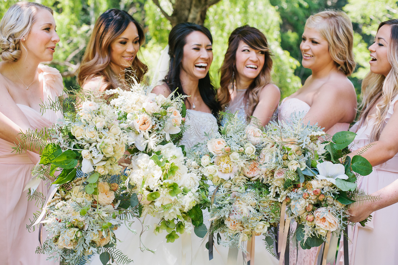 a group of bridesmaids with bright bouquets