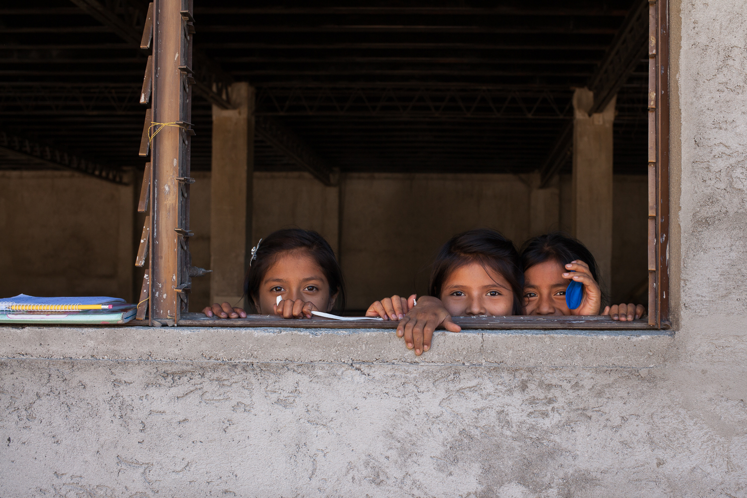kids looking out through a window