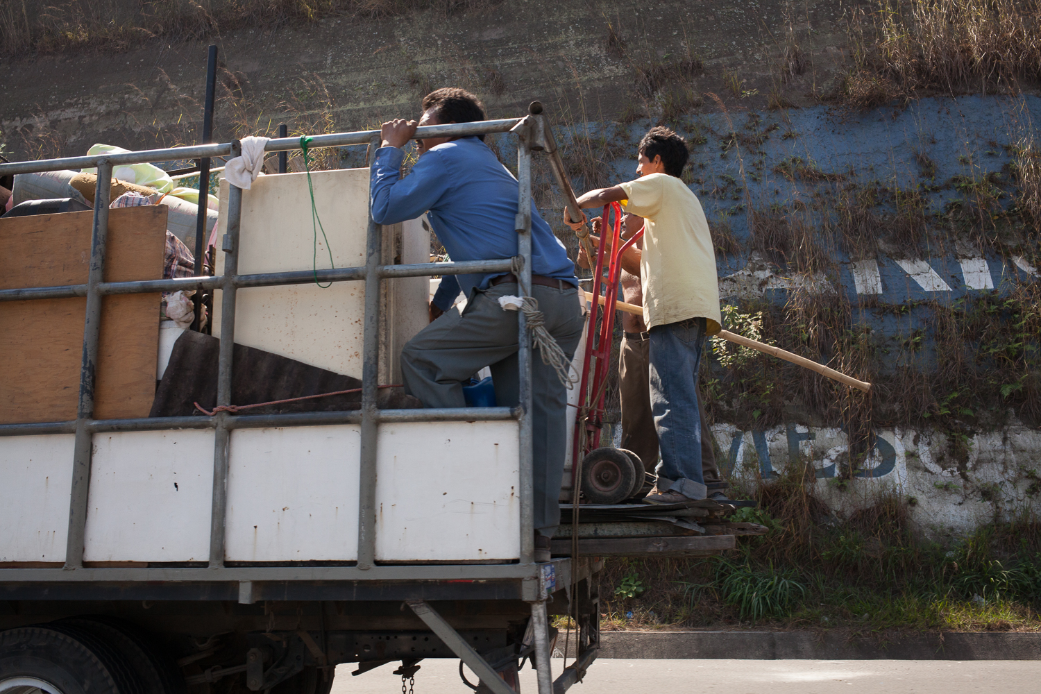 People riding in the pack of truck