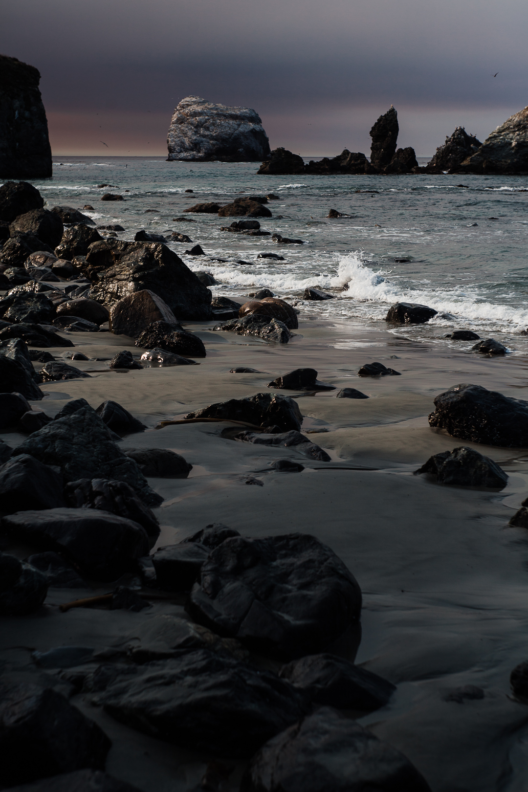 a beach with dark clouds