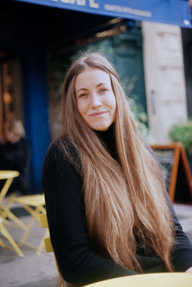 a woman sitting at french café