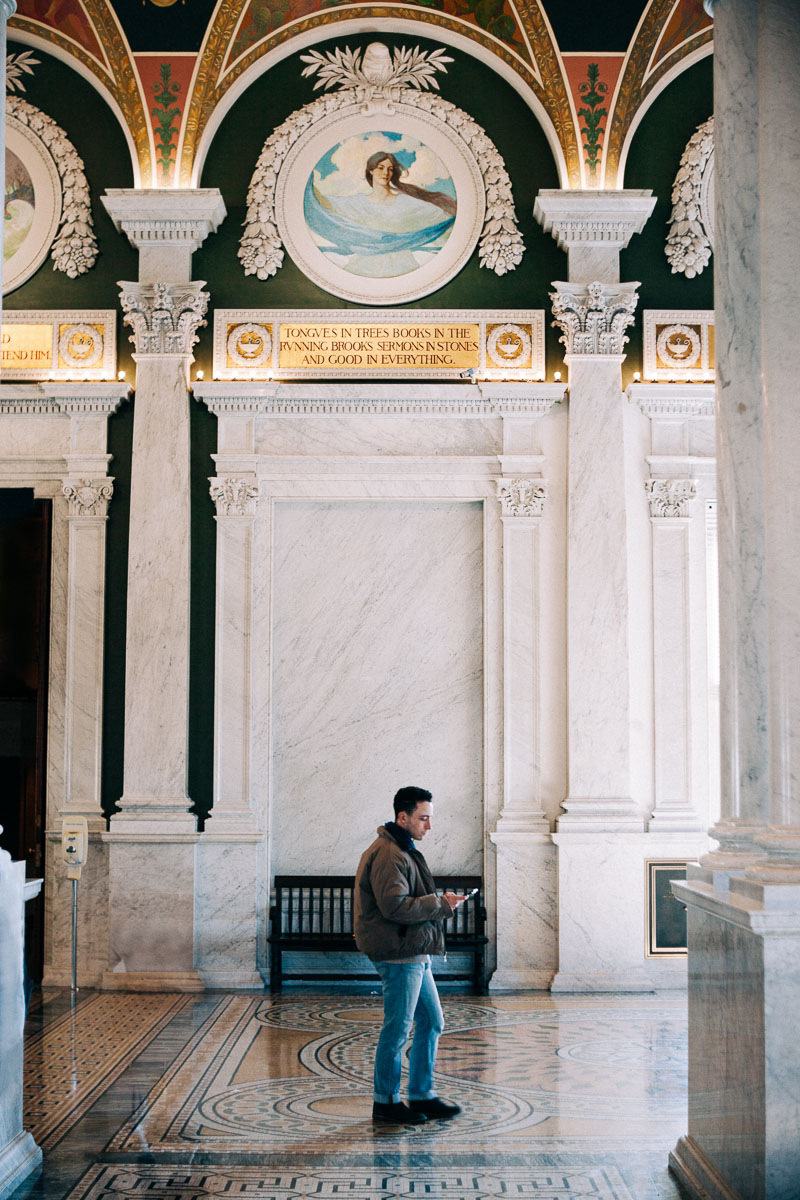 a person strolling the interior of the Library of Congress