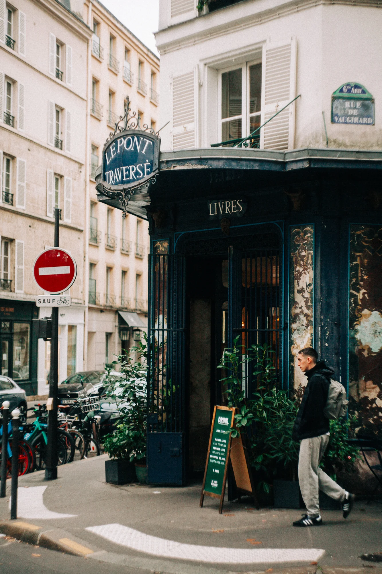 a man walking by a perisian restaurant