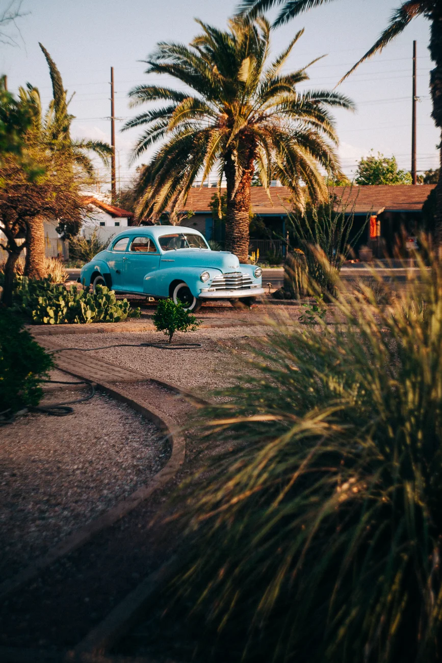 classic teal car by palm trees