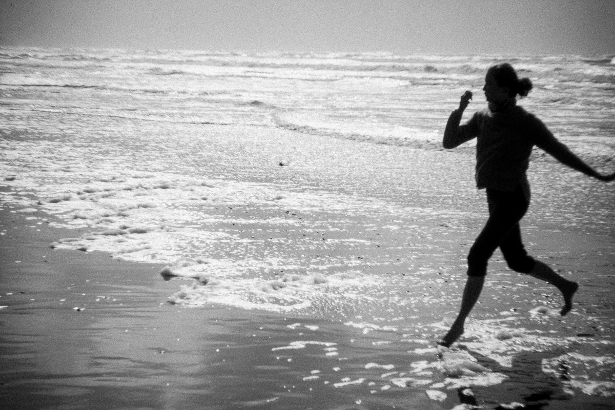 a woman running through the surf