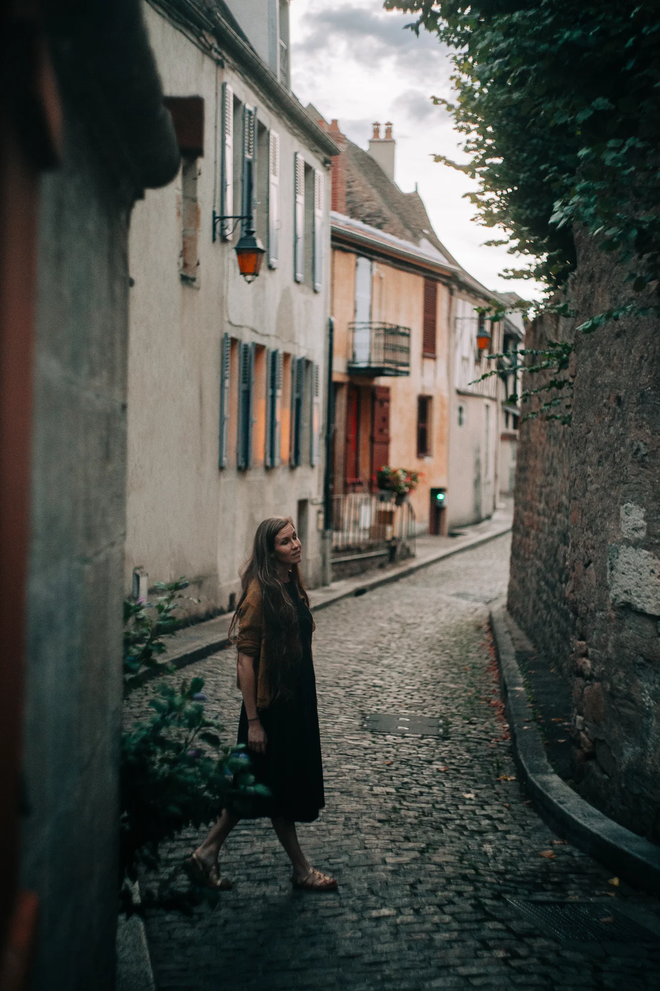 a women at dusk singing in a small european village